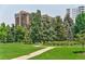 Green park with walking path, mature trees, and seating, offering a serene outdoor space at 1441 N Humboldt St # 302, Denver, CO 80218