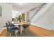 Bright dining area with modern table set, leading to the kitchen and stairs at 1699 S Trenton St # 147, Denver, CO 80231