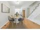 A dining room features a table for four people and a stairway leading to another floor at 1699 S Trenton St # 147, Denver, CO 80231