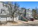 View of townhomes with attached garages and well-maintained landscaping at 1699 S Trenton St # 147, Denver, CO 80231