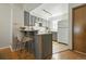 Efficient kitchen featuring ample cabinets, a breakfast bar, and modern appliances at 1699 S Trenton St # 147, Denver, CO 80231