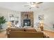 Living room showcases a stone fireplace, ceiling fan, and sliding glass doors that lead to the outside at 1699 S Trenton St # 147, Denver, CO 80231