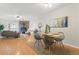 Open-concept living and dining area featuring a fireplace, hardwood floors and natural light at 1699 S Trenton St # 147, Denver, CO 80231