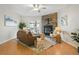 Cozy living room featuring a stone fireplace, ceiling fan, and sliding glass doors to balcony at 1699 S Trenton St # 147, Denver, CO 80231