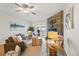 Inviting living room featuring a stone fireplace, ceiling fan, and hardwood floors at 1699 S Trenton St # 147, Denver, CO 80231