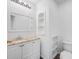 Modern half bathroom with white subway tiles, marble countertop, and recessed shelving at 1334 Carriage Dr, Longmont, CO 80501