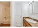 Bathroom featuring a shower over tub, a granite-look vanity, and vinyl flooring at 1334 Carriage Dr, Longmont, CO 80501