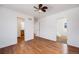 Light and airy bedroom featuring hardwood floors and a glimpse into the bathroom at 1334 Carriage Dr, Longmont, CO 80501