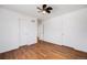 Bright bedroom with hardwood floors, white walls, and a ceiling fan at 1334 Carriage Dr, Longmont, CO 80501