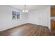 Well-lit dining room featuring new hardwood flooring and a modern chandelier at 1334 Carriage Dr, Longmont, CO 80501