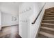 Bright entryway with coat hooks, and view to living area with wood floors, and carpeted stairs with wooden handrail at 1334 Carriage Dr, Longmont, CO 80501