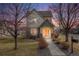 Charming two-story home with stone accents, inviting front porch, and manicured lawn at 1334 Carriage Dr, Longmont, CO 80501