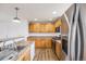 This open eat-in kitchen features stainless steel appliances, and lots of light wood cabinets at 1334 Carriage Dr, Longmont, CO 80501