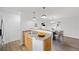 Stylized view of the open kitchen with a breakfast bar that opens to the dining room at 1334 Carriage Dr, Longmont, CO 80501