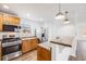 The eat-in kitchen features stainless steel appliances, a breakfast bar and light wood cabinets at 1334 Carriage Dr, Longmont, CO 80501