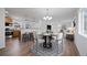 Stylized living room with an open concept design adjacent to the kitchen with a dining table at 1334 Carriage Dr, Longmont, CO 80501