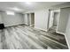 Spacious basement featuring modern gray floors and neutral-toned walls, offering a versatile living space at 4901 Bryant St, Denver, CO 80221