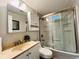 Clean bathroom featuring a shower over tub with sliding glass doors, providing a functional and modern space at 4901 Bryant St, Denver, CO 80221