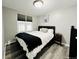 Well-lit bedroom featuring a bed, window with blinds, and stylish decor, creating a tranquil retreat at 4901 Bryant St, Denver, CO 80221