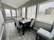 Bright dining room with big windows and new table and chairs at 4901 Bryant St, Denver, CO 80221