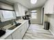 Modern kitchen featuring white cabinets, a stainless steel sink, and updated appliances at 4901 Bryant St, Denver, CO 80221