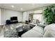 Spacious living room featuring hardwood floors, with a comfortable sofa and TV at 4901 Bryant St, Denver, CO 80221