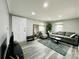 Bright living room featuring hardwood floors, a comfortable sofa, and natural light at 4901 Bryant St, Denver, CO 80221