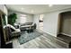Cozy living room features hardwood floors, a comfortable sofa, and view to the kitchen at 4901 Bryant St, Denver, CO 80221