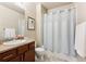 Cozy bathroom with shower and tub, a vanity with a mirror, and neutral walls at 12564 Madison Way, Thornton, CO 80241