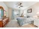 Comfortable bedroom with a queen bed, soft blue bedding, and a ceiling fan at 12564 Madison Way, Thornton, CO 80241