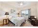 Relaxing bedroom with a queen-sized bed, soft lighting, and window with blinds at 12564 Madison Way, Thornton, CO 80241