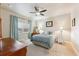 Calm bedroom with a queen bed, soft blue bedding, and large window for natural light at 12564 Madison Way, Thornton, CO 80241