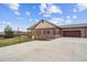 Charming single-story home with red siding, stone accents, and a well-kept lawn at 12564 Madison Way, Thornton, CO 80241