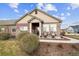 Attractive single-story home with a covered entry and stone accents, complemented by well-maintained landscaping at 12564 Madison Way, Thornton, CO 80241