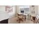 Bright home office featuring a modern white desk and comfortable wooden chair at 12564 Madison Way, Thornton, CO 80241