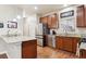 A well-lit kitchen featuring stainless steel appliances, granite countertops, and modern cabinetry at 12564 Madison Way, Thornton, CO 80241