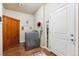 Functional laundry room with modern appliances, wooden accents, and ample storage space at 12564 Madison Way, Thornton, CO 80241