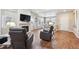Spacious living room with hardwood floors, a fireplace, and large windows for natural light at 12564 Madison Way, Thornton, CO 80241