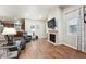Open-concept living room with a fireplace, hardwood floors, and easy access to the kitchen at 12564 Madison Way, Thornton, CO 80241