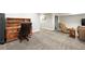 Finished basement area featuring neutral carpet, desk with hutch, and comfortable tan sofa and chair at 10842 W Evans Ave # 34, Lakewood, CO 80227