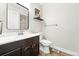 Bathroom with a vanity, mirror, toilet, towel bar and artwork at 10842 W Evans Ave # 34, Lakewood, CO 80227