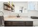 Bathroom vanity with open shelving, framed mirror, and a decorative sink at 10842 W Evans Ave # 34, Lakewood, CO 80227