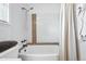 Bright bathroom featuring a tub with tile surround and a curved shower rod at 10842 W Evans Ave # 34, Lakewood, CO 80227