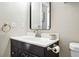 Bathroom featuring a black vanity, modern fixtures, and ample counter space at 10842 W Evans Ave # 34, Lakewood, CO 80227