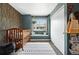 Cozy bedroom with a crib, large window with a window seat and a closet at 10842 W Evans Ave # 34, Lakewood, CO 80227