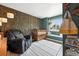 Cozy Bedroom with charming décor, a wooden crib, and a comfortable armchair, perfect for a new Gathering at 10842 W Evans Ave # 34, Lakewood, CO 80227