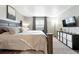 Spacious bedroom featuring a bed with soft blankets, window and decorative shelving at 10842 W Evans Ave # 34, Lakewood, CO 80227