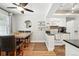 Open dining area adjacent to the kitchen featuring a table with seating and modern decor at 10842 W Evans Ave # 34, Lakewood, CO 80227