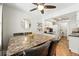 The dining area, conveniently located next to the kitchen, has ample seating and natural light at 10842 W Evans Ave # 34, Lakewood, CO 80227