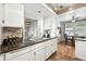 Bright kitchen featuring a stainless steel sink, modern appliances, and an open floor plan at 10842 W Evans Ave # 34, Lakewood, CO 80227